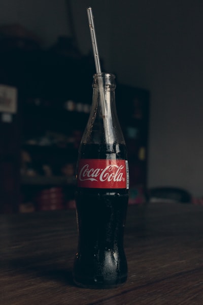 coca cola bottle on brown wooden table