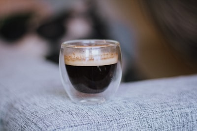 a close up of a cup of coffee on a couch